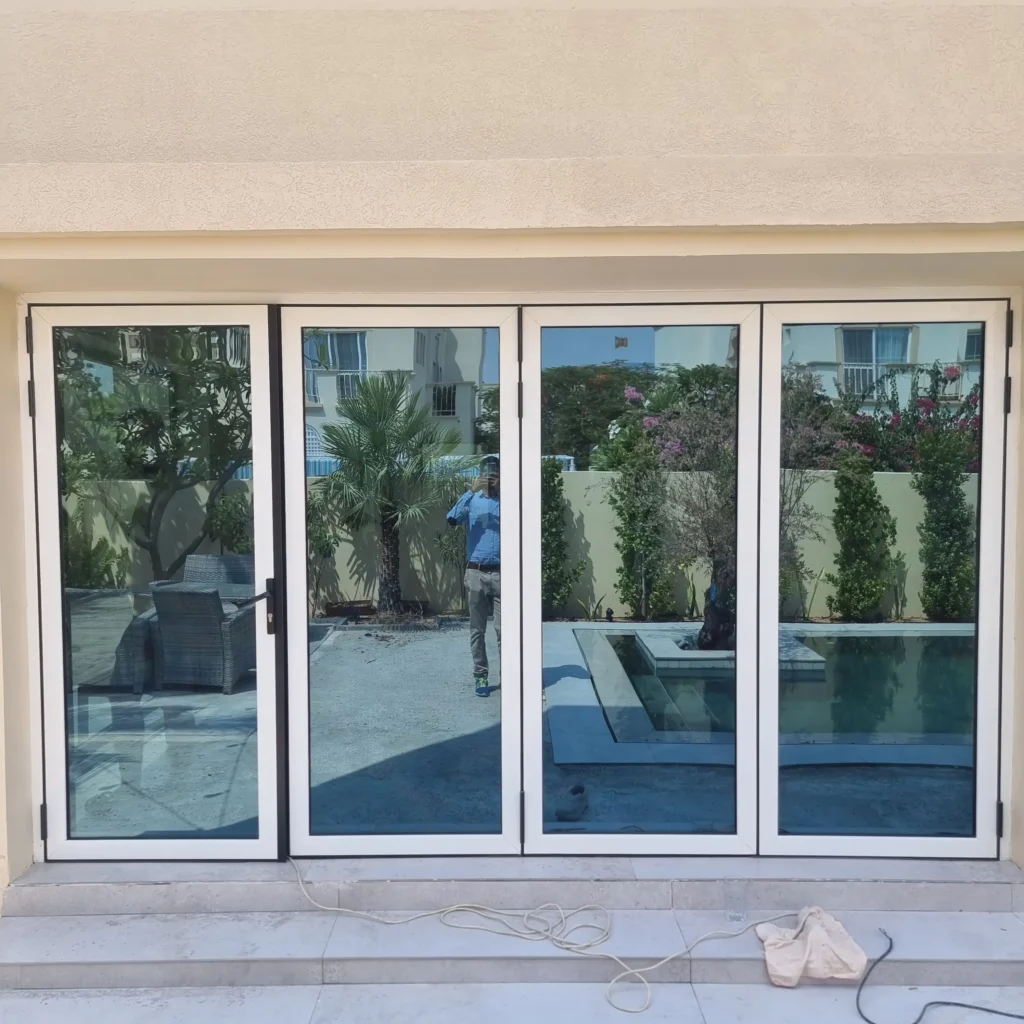 Modern thermal break aluminium folding doors with high-performance glass for energy efficiency in UAE.