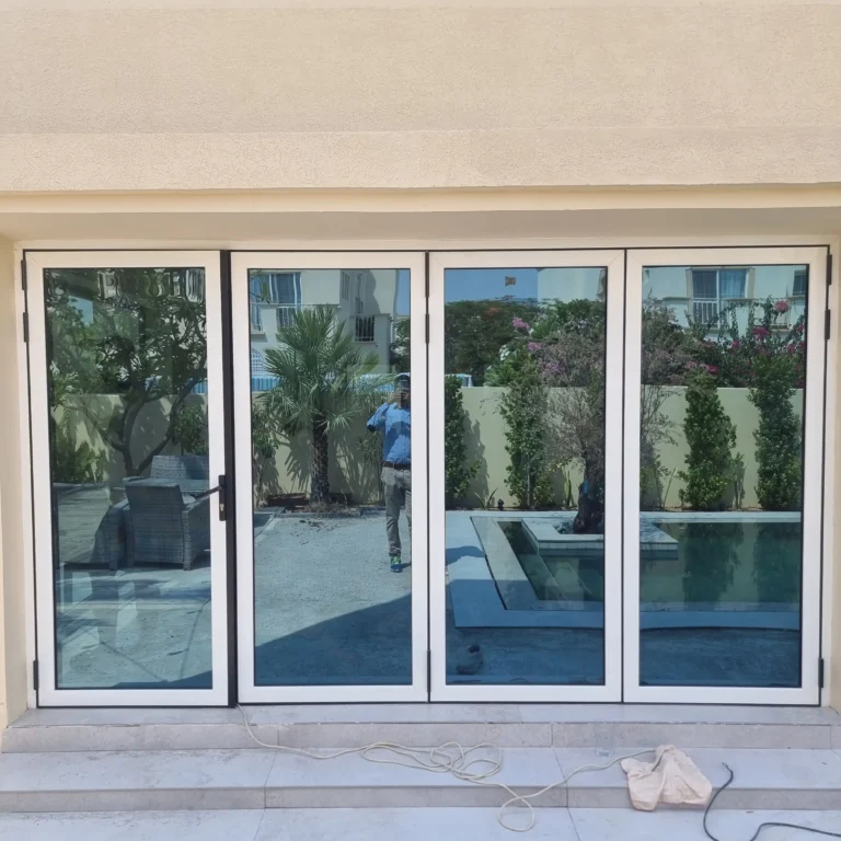 Modern thermal break aluminium folding doors with high-performance glass for energy efficiency in UAE.