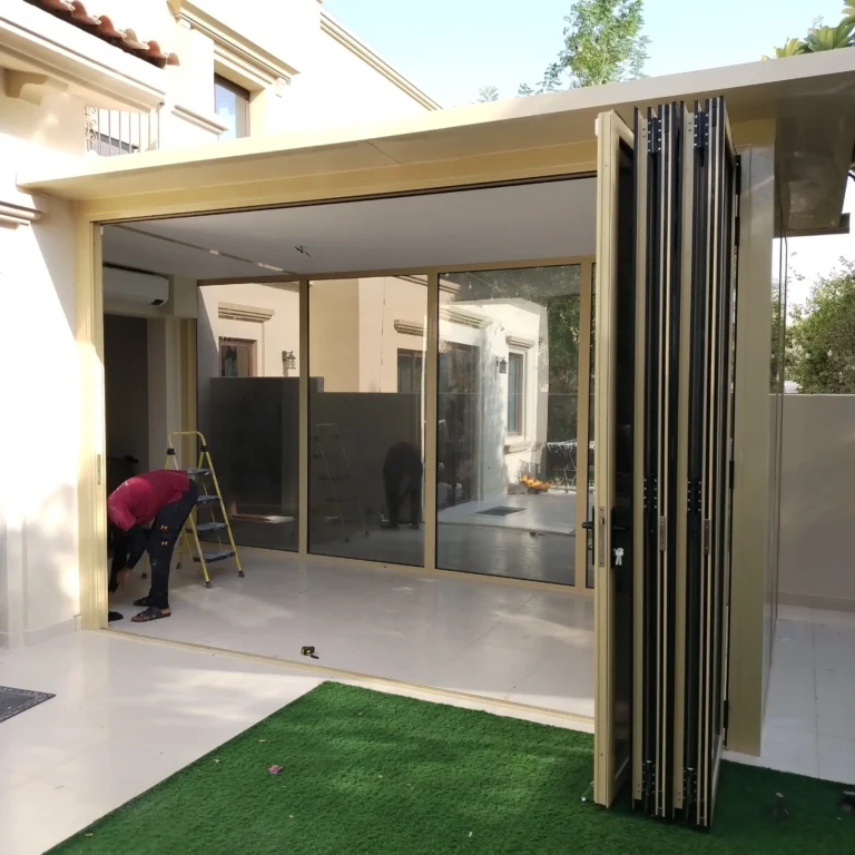 Weather-resistant external aluminium folding door system designed for high-end garden extensions.