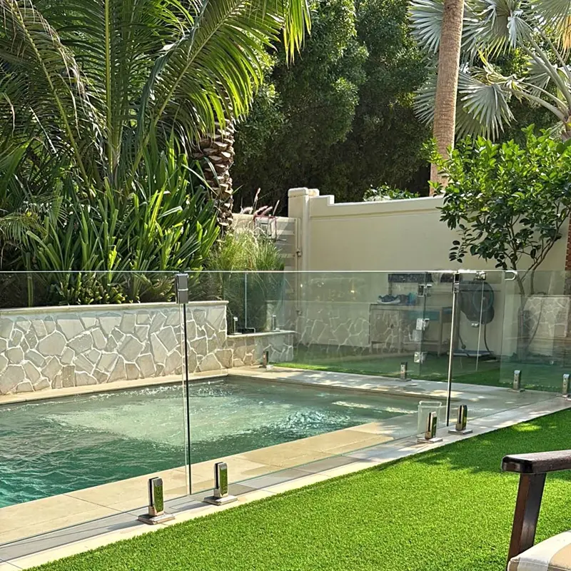 High-quality safety glass fence for swimming pools with child-safe gate system.