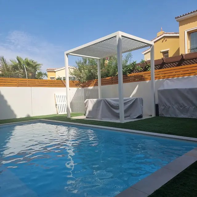 Independent four-post aluminium pergola for private backyard seating area.