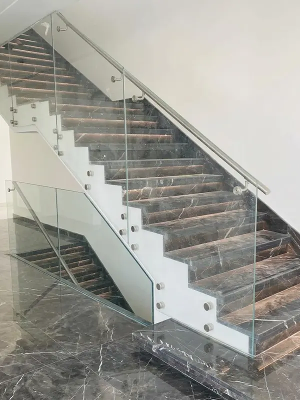 Durable glass balustrade with stainless steel top rail and vertical support posts.