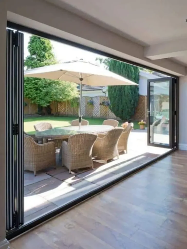Luxury aluminium bifolding doors opening to a garden and patio area.