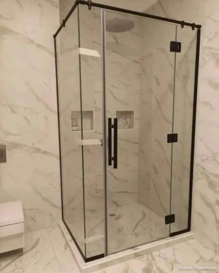 Space-saving corner entry glass shower cabin with polished chrome profiles.