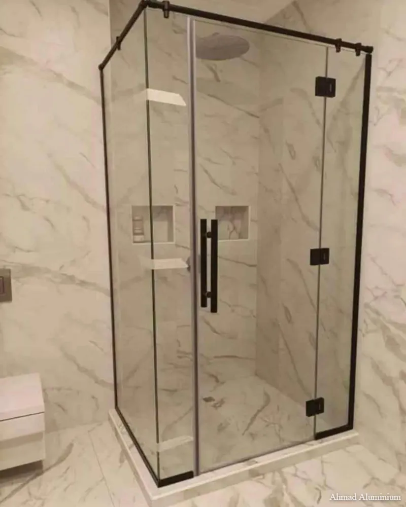 Space-saving corner entry glass shower cabin with polished chrome profiles.