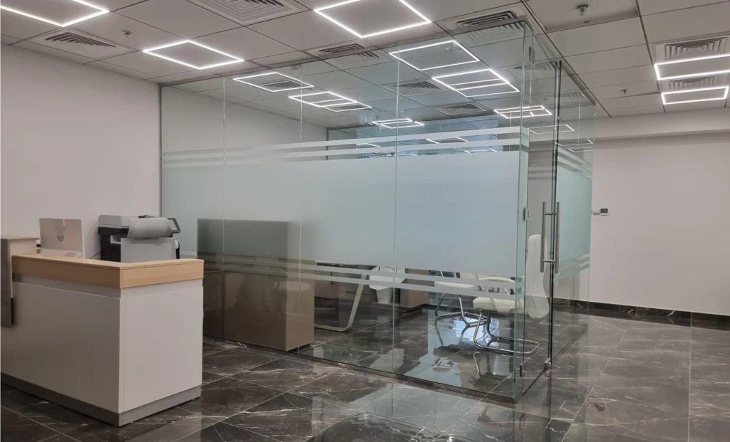 Custom curved tempered glass partition for a luxury reception or office entrance.