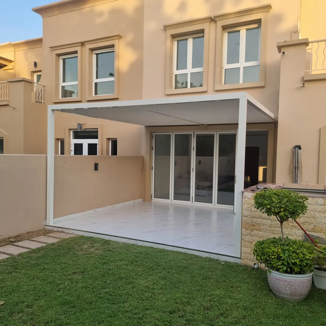 Modern aluminium pergola with a fixed laminated glass roof for UV protection and natural light.