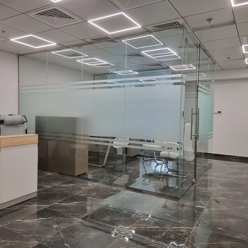 Modern frameless office glass partition for an open and bright workspace environment.