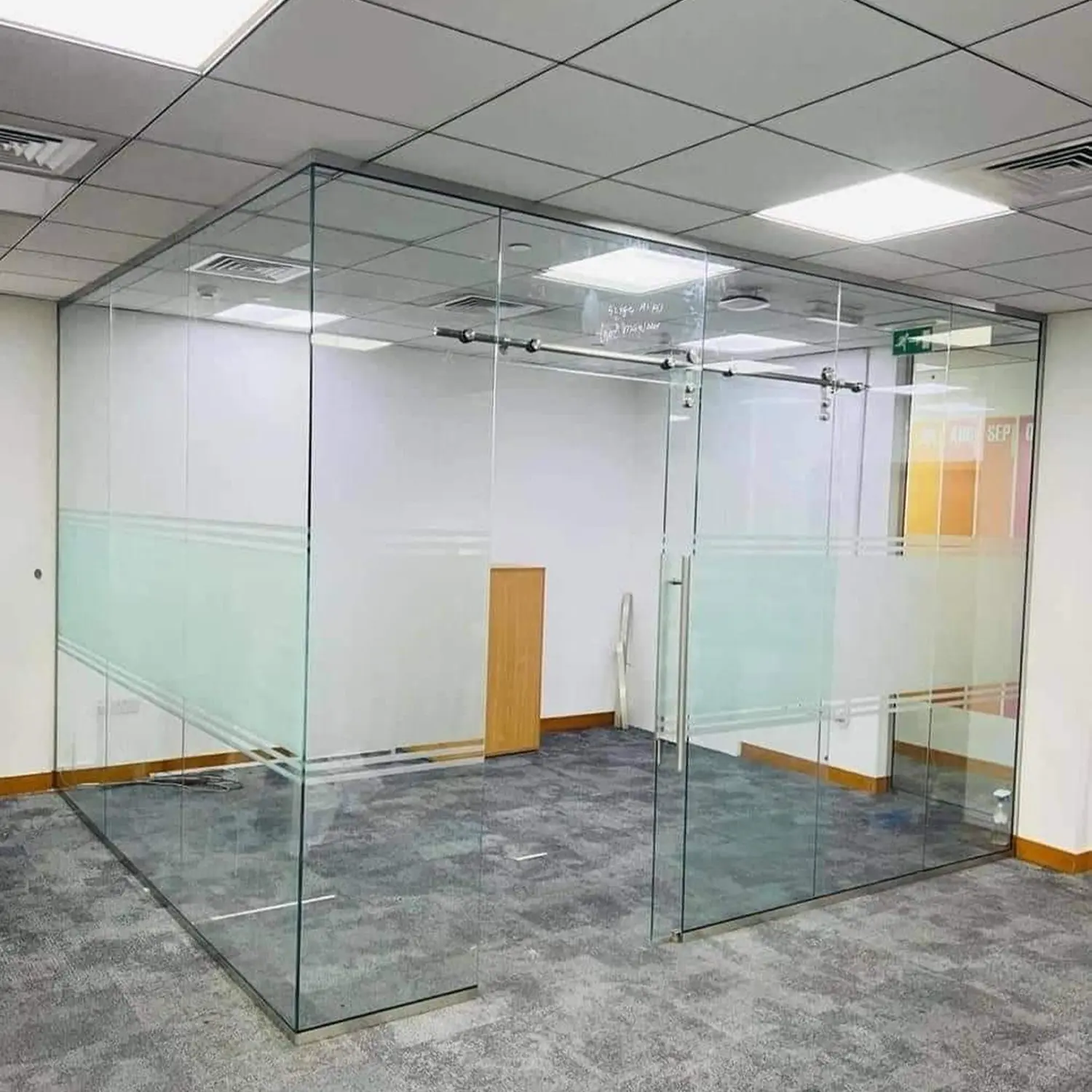 Frameless glass office pod for individual work or small video conference calls.