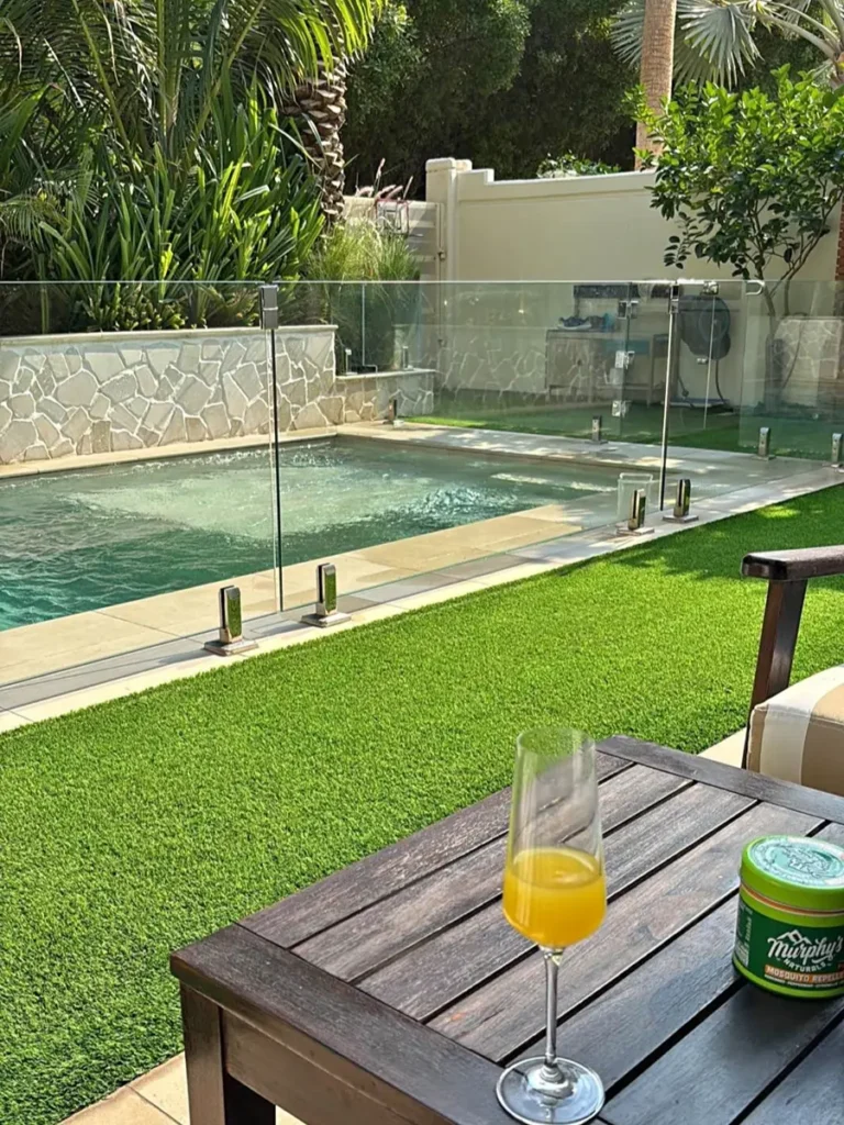 Clear tempered glass pool fencing with stainless steel spigots for safety.