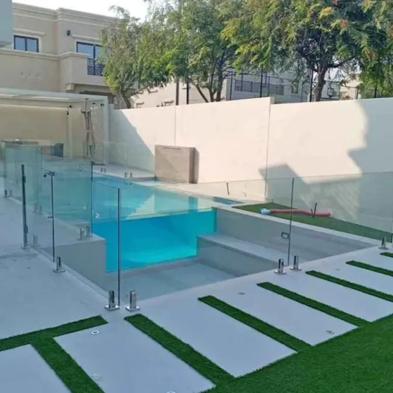 Safety glass pool fence featuring a slim matte black aluminium top rail for secure grip and style.