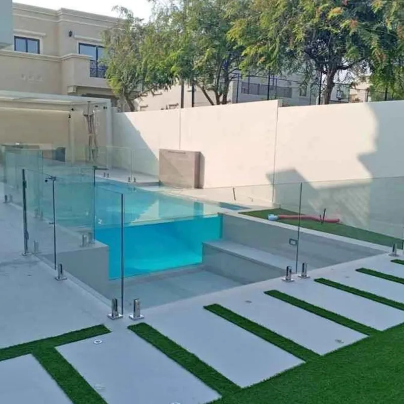 Safety glass pool fence featuring a slim matte black aluminium top rail for secure grip and style.