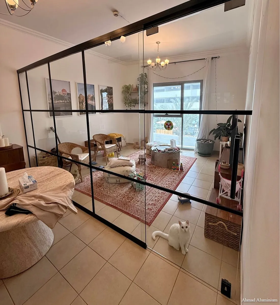 Minimalist home office glass partition with black aluminium frame for privacy and light.