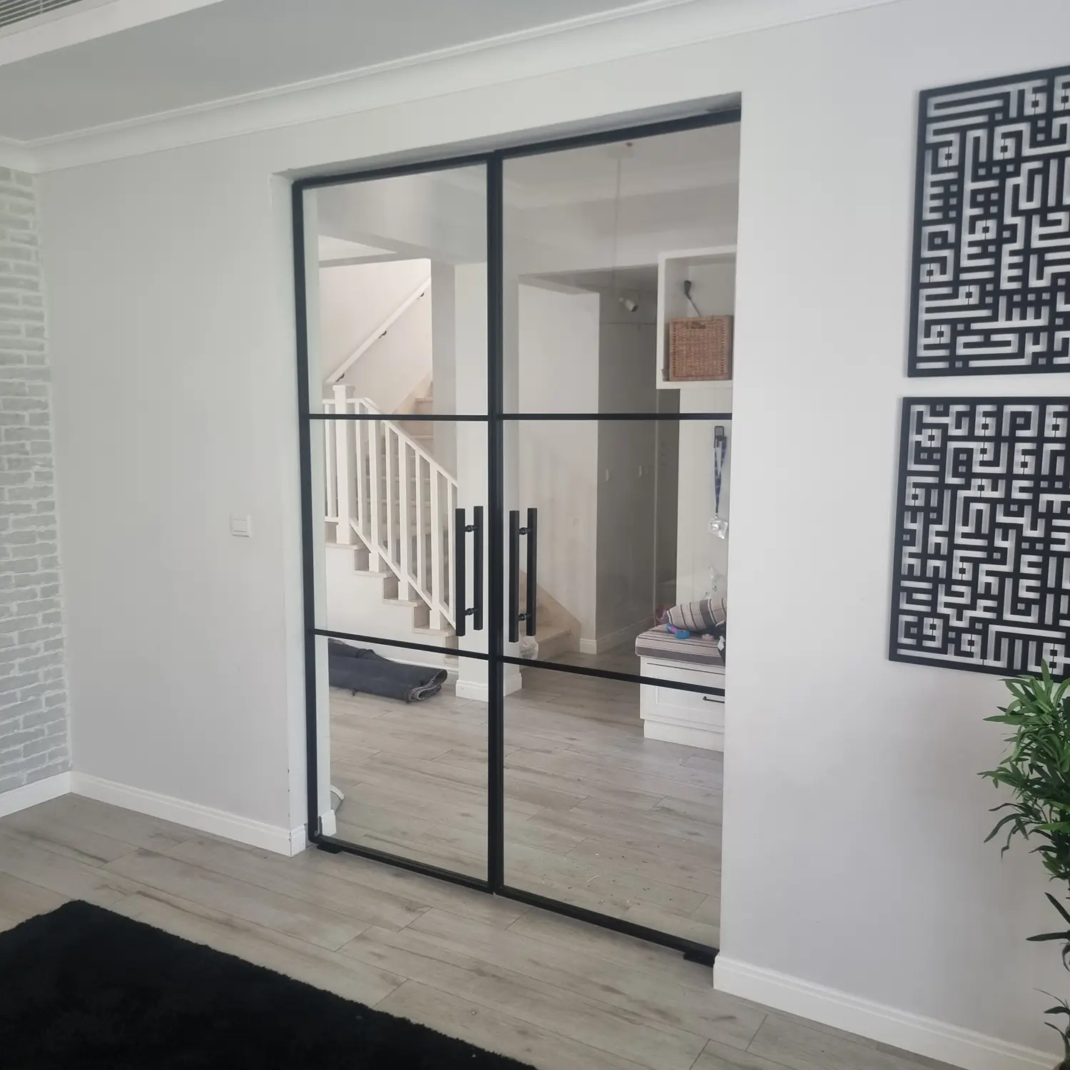 Modern glass partition door with slim aluminium frames for stylish home office separation.