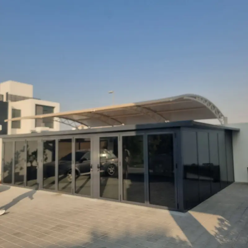 Modern outdoor glass room extension for villa gardens providing protection from the elements.