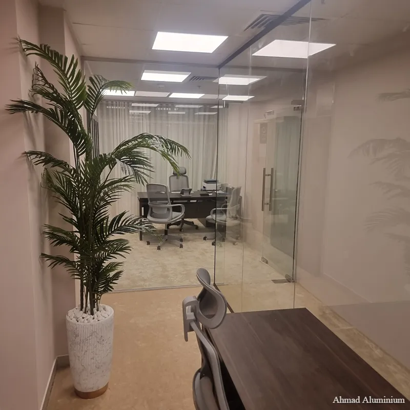 Sleek frameless glass partition for an executive manager's office featuring a slim aluminium profile.