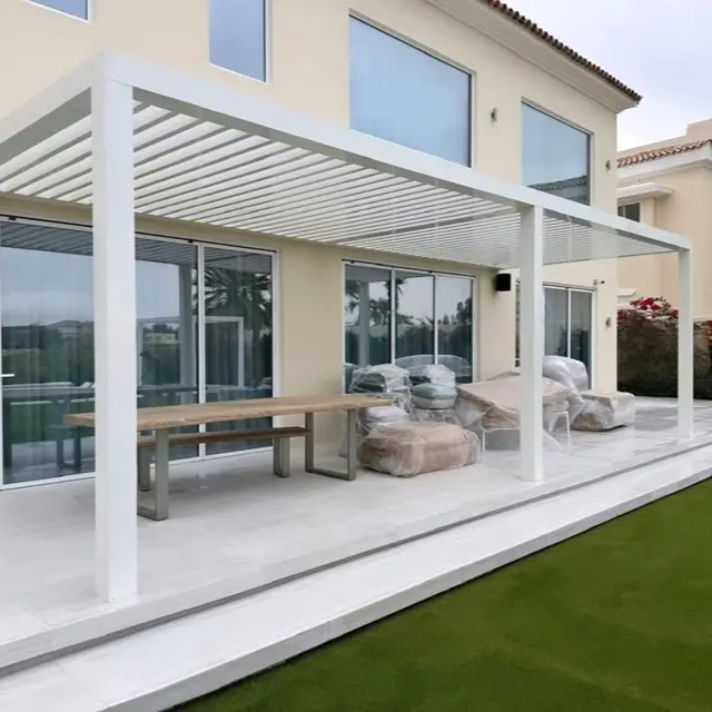 ustom-designed L-shaped aluminium pergola with motorized louvers for a modern villa terrace