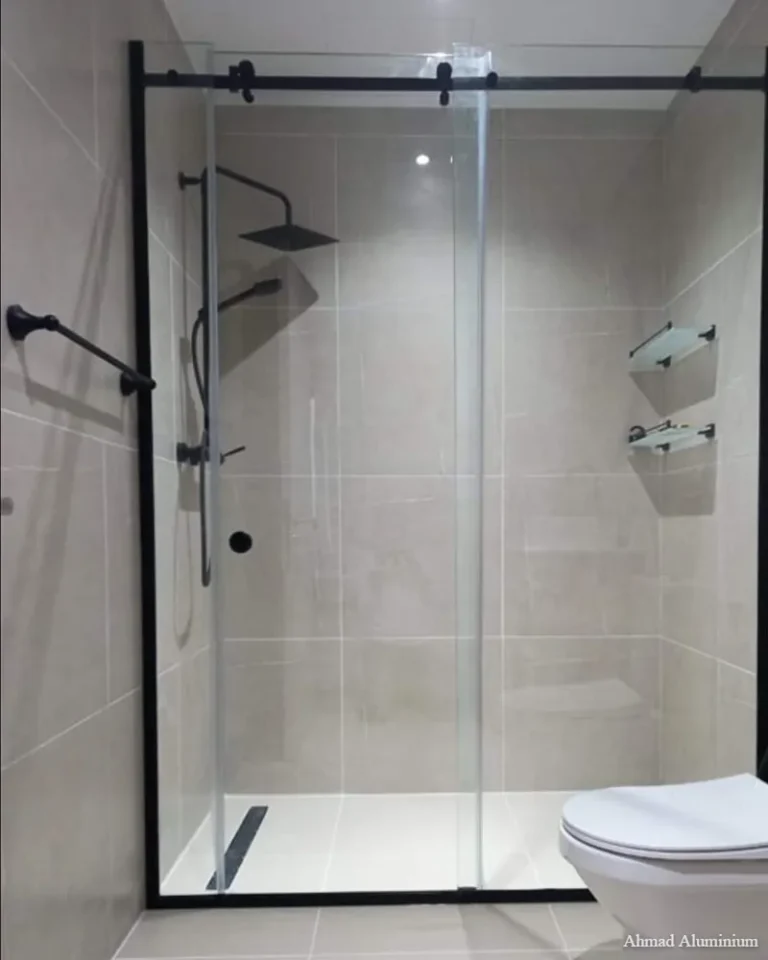 Smooth-sliding glass shower door with stainless steel tracks and rollers.