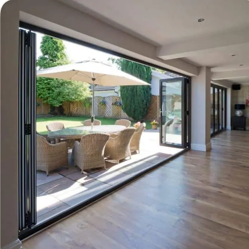 Space-saving aluminium bifolding doors that fold completely to create a wide-open garden view.