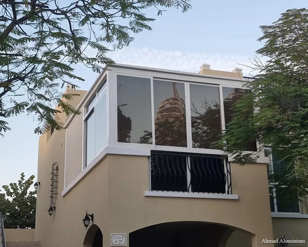 Outdoor rooftop terrace enclosure with sliding glass doors and high-performance weather sealing.