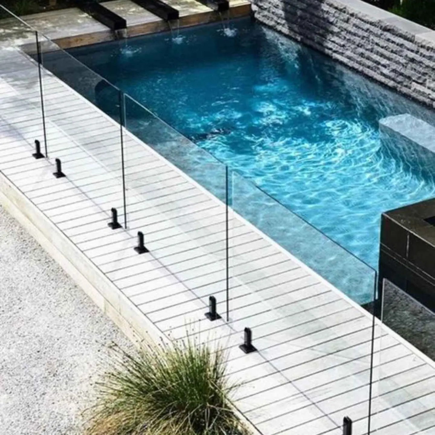 12mm thick tempered safety glass pool surround with high-quality floor-mounted brackets.
