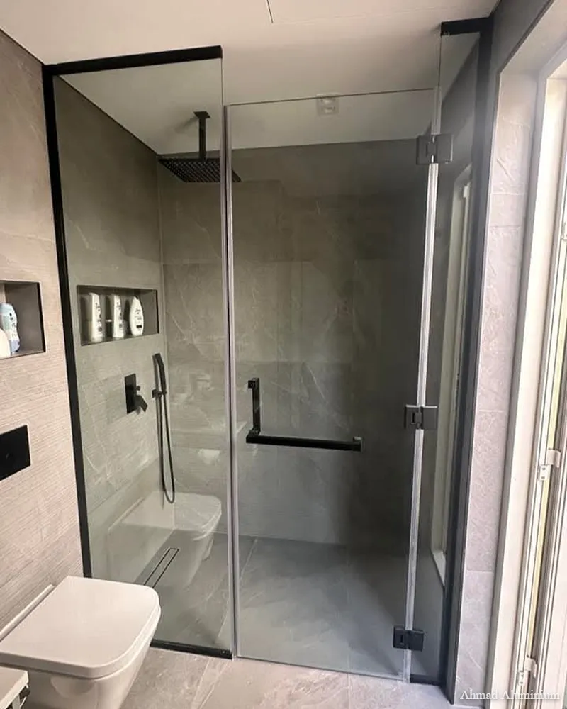 Frameless 10mm tempered glass shower enclosure installed in a modern Dubai villa.