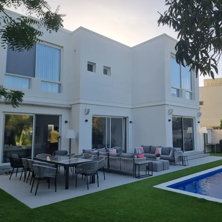 Modern glass house extension with integrated aluminium structural beams and sliding doors.