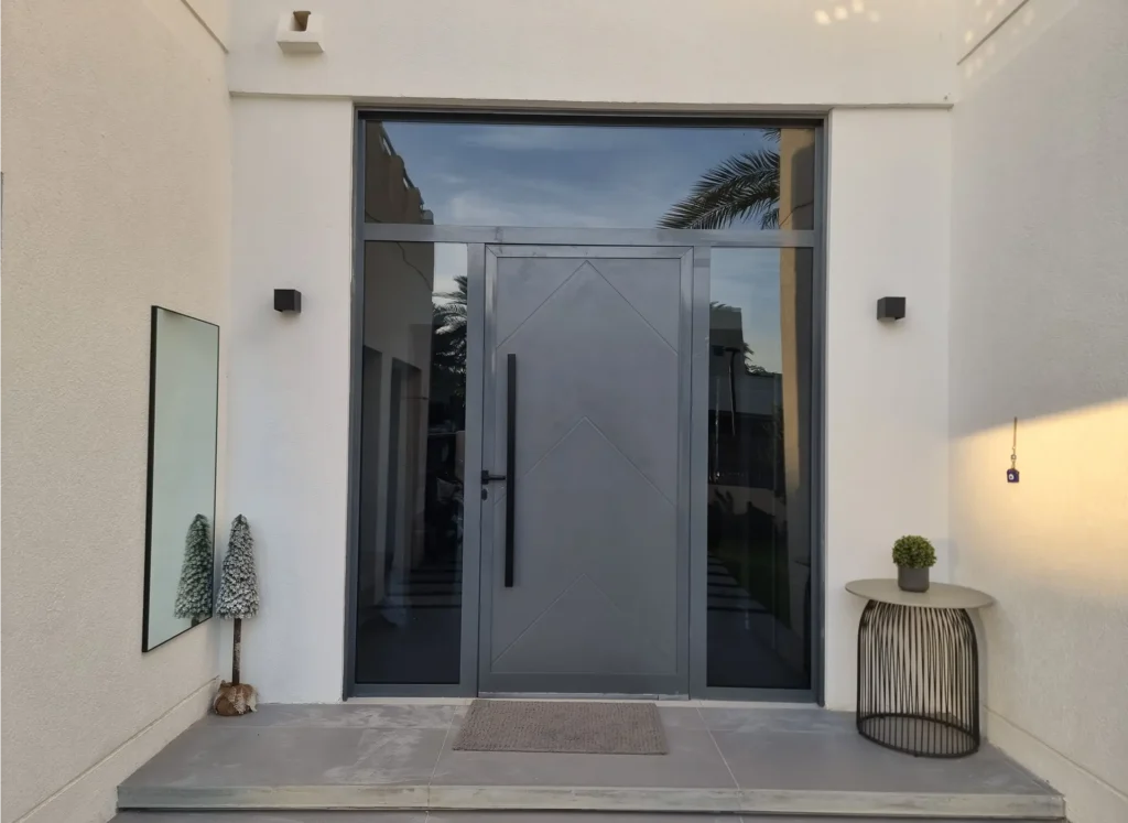 Durable aluminium front door with a natural wood-grain powder coating for a classic villa look.