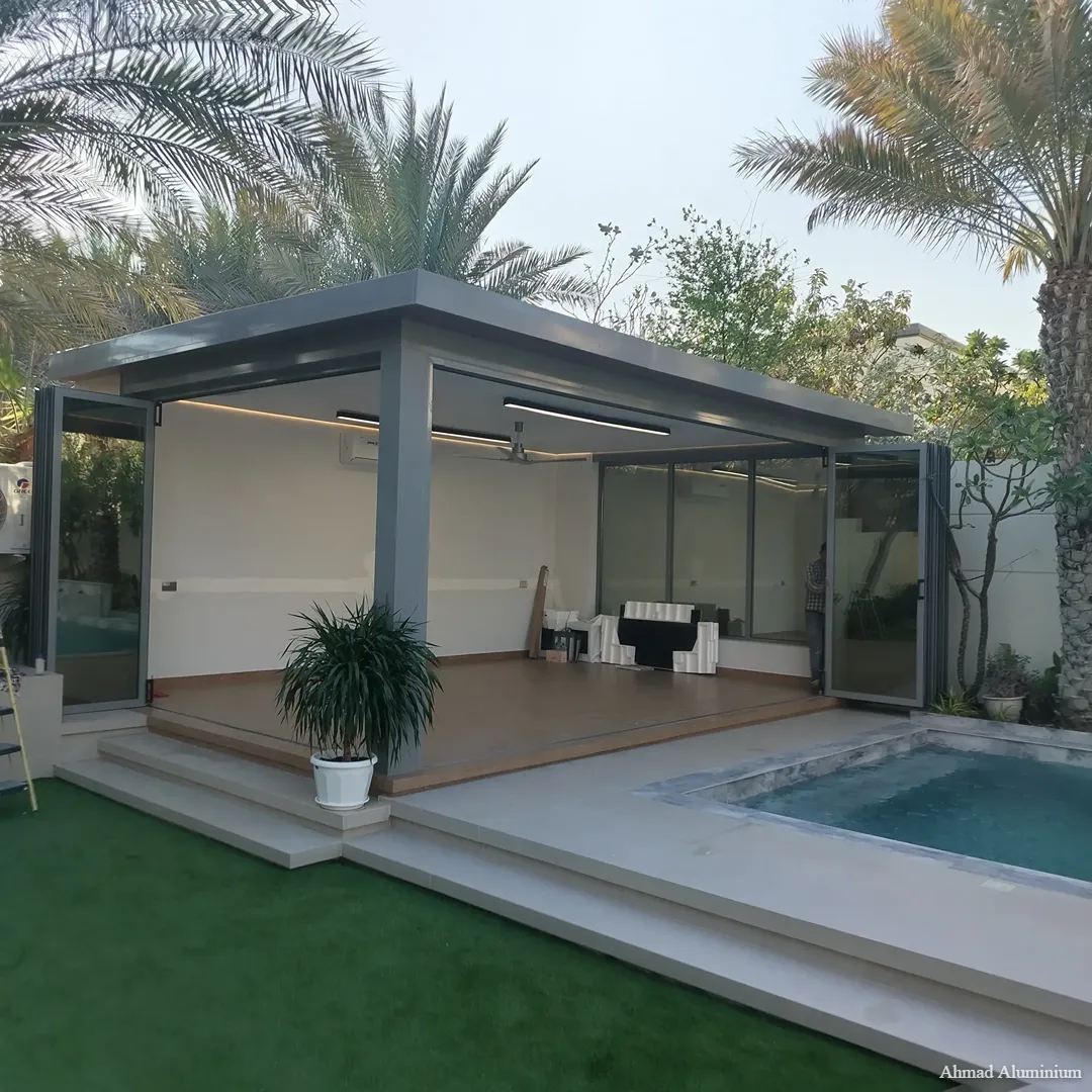 Custom garden glass room extension with folding doors in a Dubai villa.